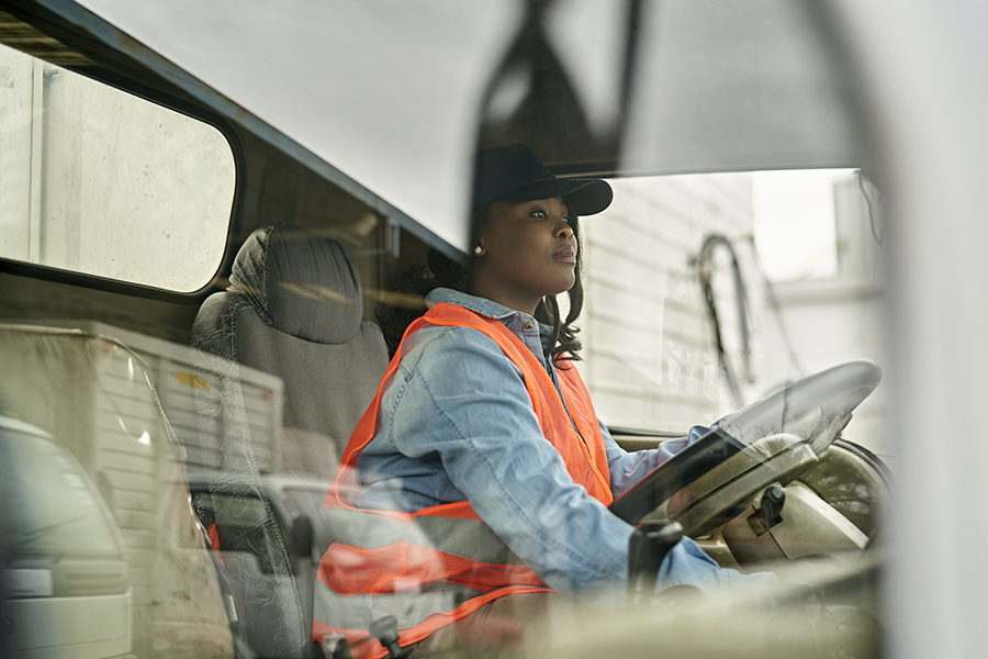 Portrait Of Courier With Digital Tablet Delivering Package